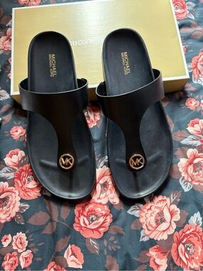 Michael Kors Black Thong Sandals with Gold MK Medallion